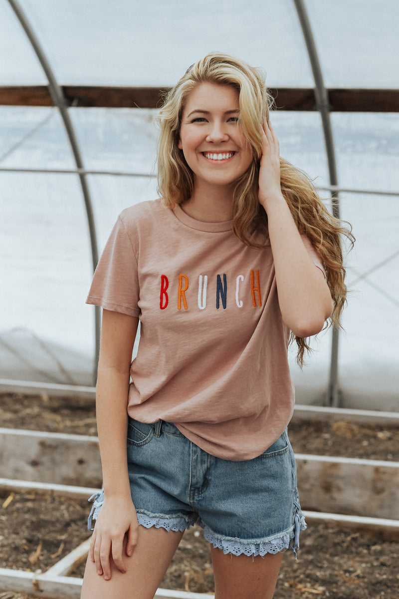 Must have mauve tee with multi-colored letters spelling BRUNCH 100% Cotton