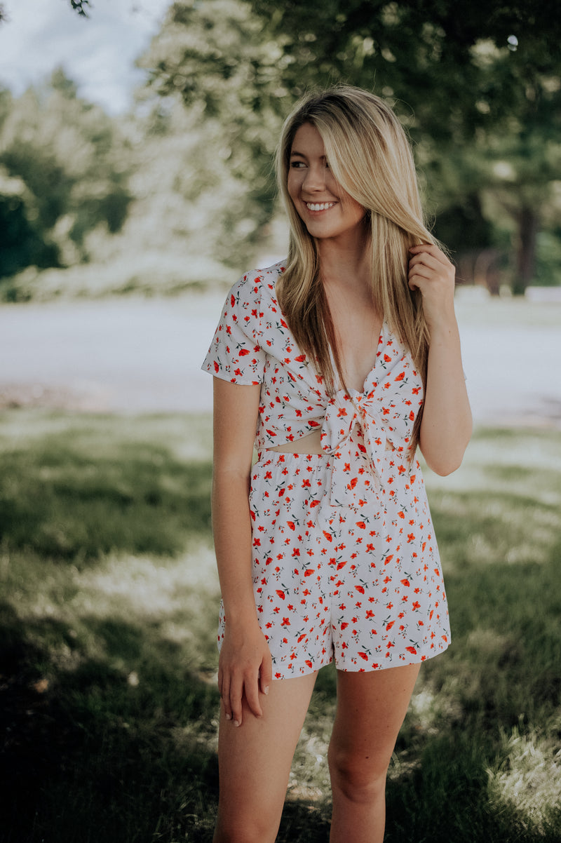 Adorable white romper with red flower design